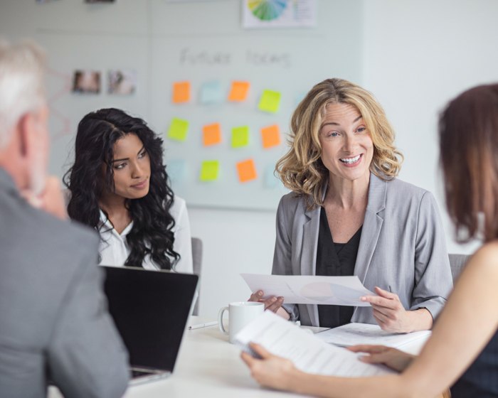 Businesswoman discussing with colleagues in office